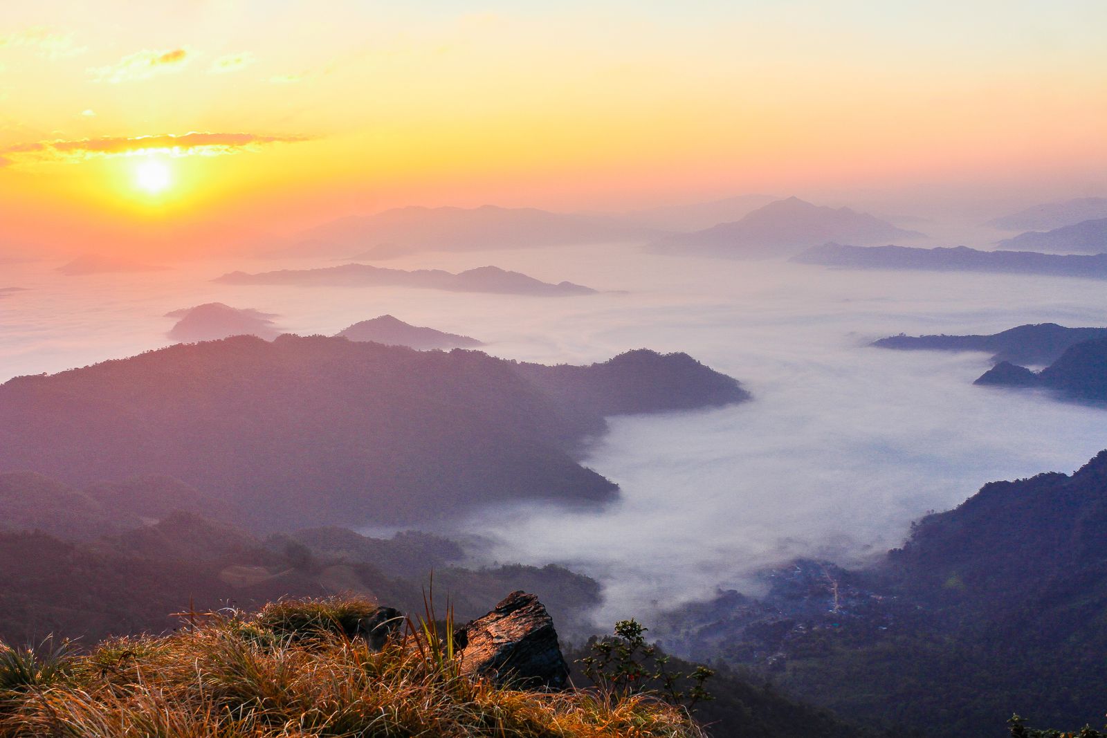 Sunrise over mist-filled valleys and distant ridges