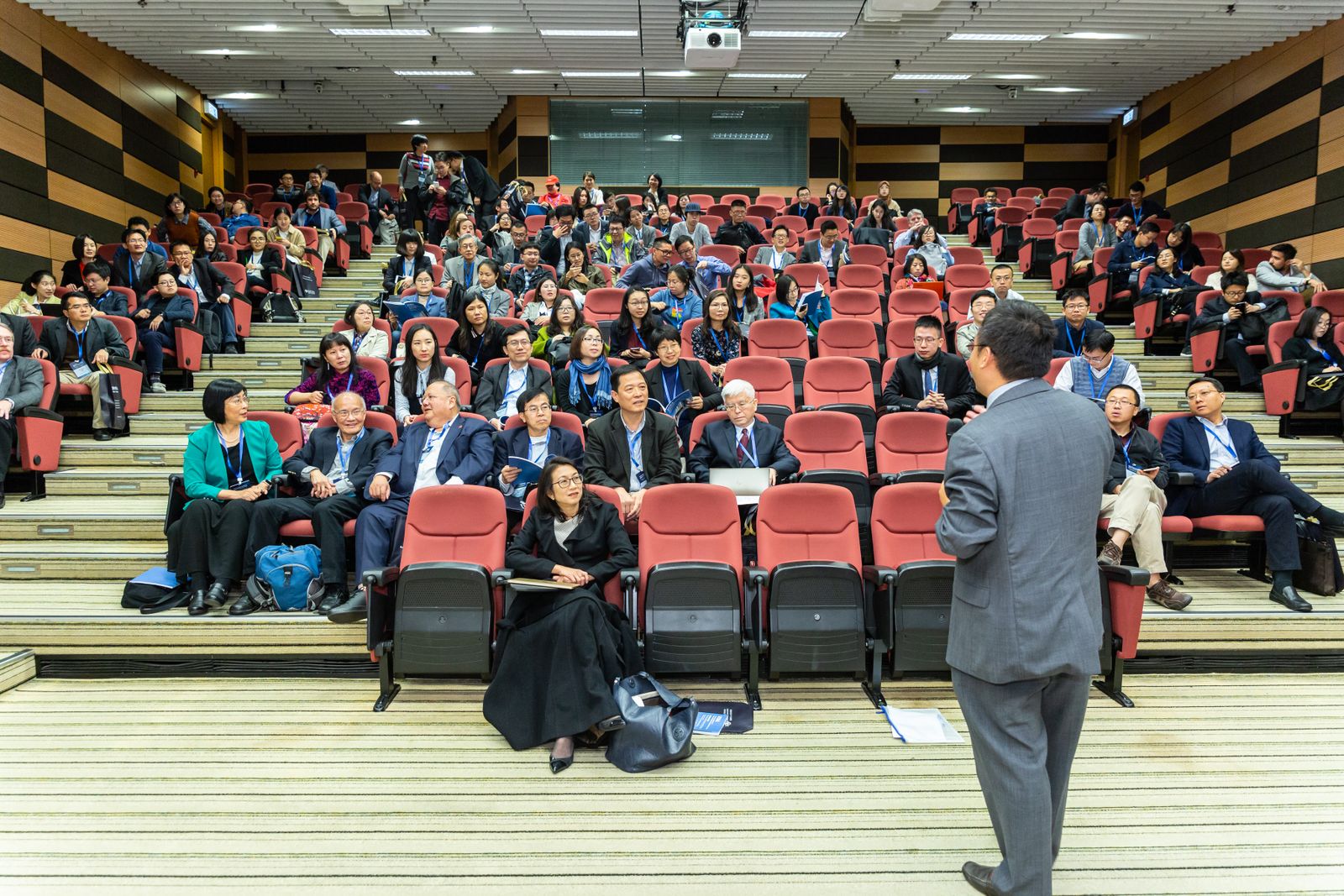 A speaker addressing an engaged audience at a conference
